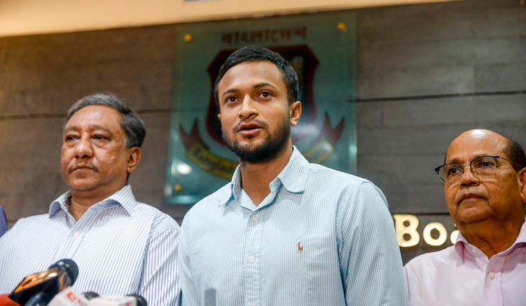 Shakib Al Hasan (centre) speaks with media as BCB president Nazmul Hassan Papon (left) stands next to him at the Sher-e-Bangla National Stadium in Dhaka | AFP