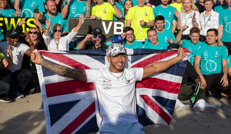 Lewis Hamilton and the Mercedes AMG Petronas F1 Team pose for a celebratory photo following the F1 Grand Prix of USA | AFP