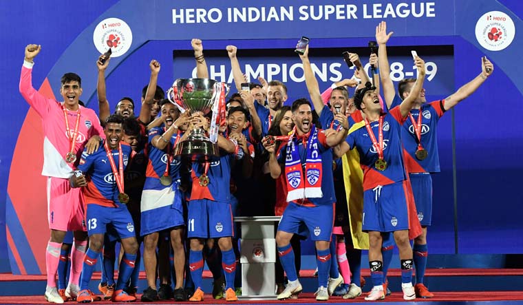 Bengaluru FC players celebrate with the winning trophy after beating Goa FC in the ISL 2019 football final match, in Mumbai | PTI