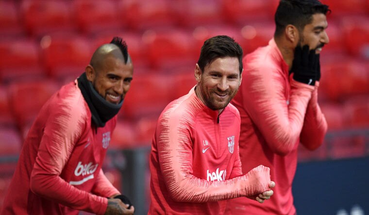 Barcelona's Chilean midfielder Arturo Vidal (left), Argentinian striker Lionel Messi (centre) and Uruguayan striker Luis Suarez attend a training session at Old Trafford stadium in Manchester, on the eve of their UEFA Champions League quarterfinal first-leg match against Manchester United | AFP