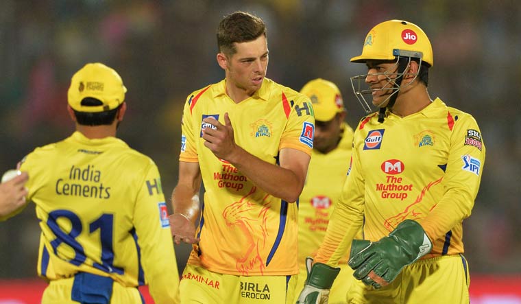 Chennai Super Kings' Mitchell Santner (centre) with captain M.S. Dhoni (right) during the IPL match against Rajasthan Royals | AFP