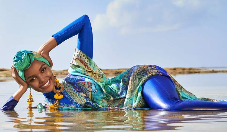Halima Aden wearing a hijab and burkini on the cover of Sports Illustrated swimsuit issue | Sports Illustrated via Twitter