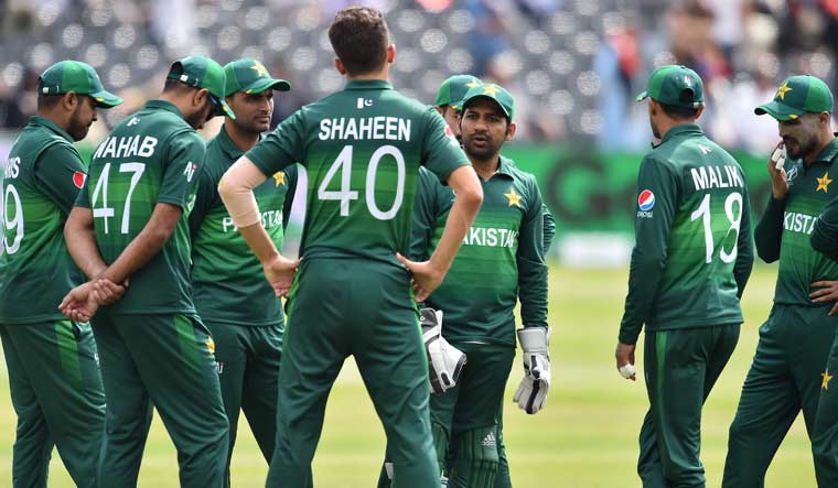 Pakistan captain Sarfaraz Ahmed (third right) talks with bowler Shaheen Shah Afridi (centre) during a break in play at the 2019 Cricket World Cup warm-up match against Afghanistan in Bristol | AFP