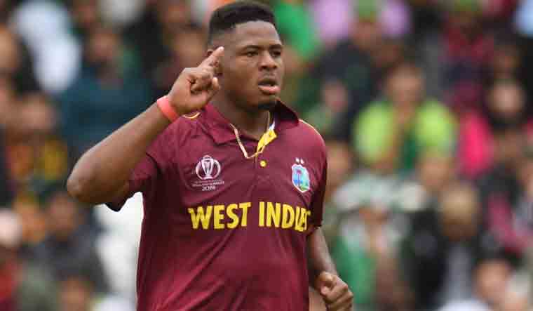 West Indies' Oshane Thomas celebrates taking the wicket of Pakistan's Shadab Khan for 0 runs during the 2019 Cricket World Cup match between West Indies and Pakistan at Trent Bridge in Nottingham | AFP