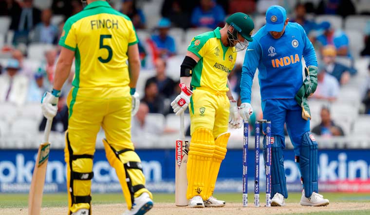 David Warner and Mahendra Singh Dhoni look on after the ball hit the stumps but did not dislodge the bails during the 2019 World Cup group stage match at The Oval in London | AFP