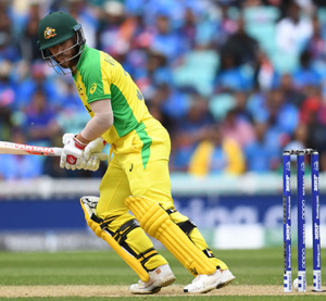 Australia's David Warner looks back as the ball touches the stumps but does not dislodge the bails during the World Cup match against India | AFP