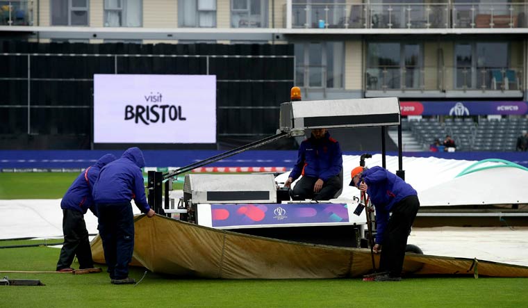 Ground staff adjust the rain covers at the County Ground in Bristol | AP