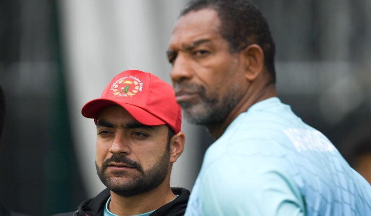 Afghanistan's Rashid Khan (left) and head coach Phil Simmons attend a training session at Old Trafford Cricket Ground in Manchester, ahead of their 2019 World Cup match against England | AFP