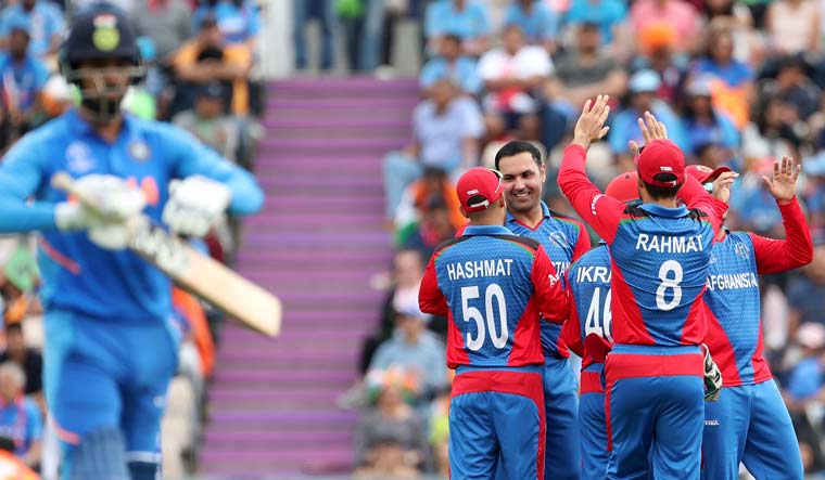 Afghanistan's Mohammad Nabi (without cap facing camera) celebrates with teammates the dismissal of India's K.L. Rahul (left) during their World Cup group match at the Hampshire Bowl in Southampton | AP