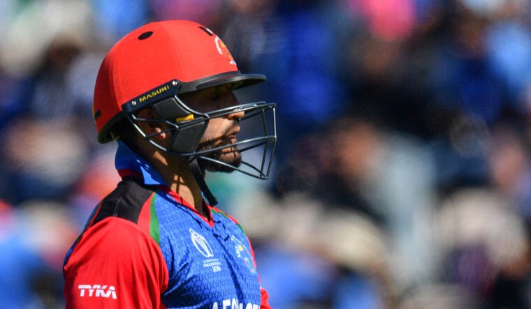 Gulbadin Naib walks back to the pavilion after being dismissed for 27 in the match against India | AFP
