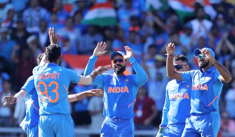 Jasprit Bumrah (second left) celebrates with teammates the dismissal of West Indies' Carlos Brathwaite during their World Cup group match at Old Trafford in Manchester | AP