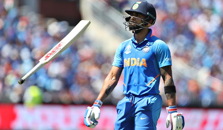 India captain Virat Kohli tosses his bat in air after being dismissed by West Indies captain Jason Holder during their World Cup group stage match at Old Trafford in Manchester | AP