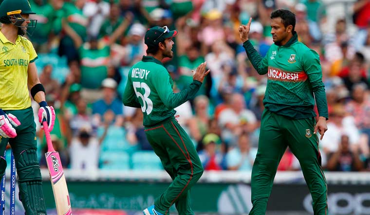 Bangladesh's Shakib Al Hasan celebrates the fall of a wicket with Mehidy Hasan Miraz in their match with South Africa at the Oval | AFP