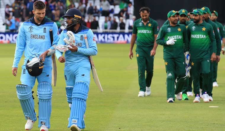 England's Mark Wood (left) and Adil Rashid walk back to the pavilion after England lost the 2019 Cricket World Cup group match against Pakistan at Trent Bridge | AFP