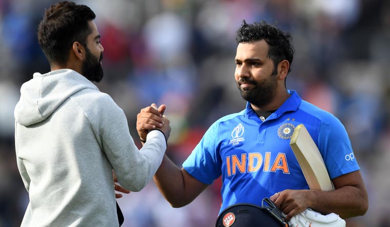 India captain Virat Kohli (left) congratulates Rohit Sharma after the team won their World Cup match against South Africa at the Rose Bowl | AFP