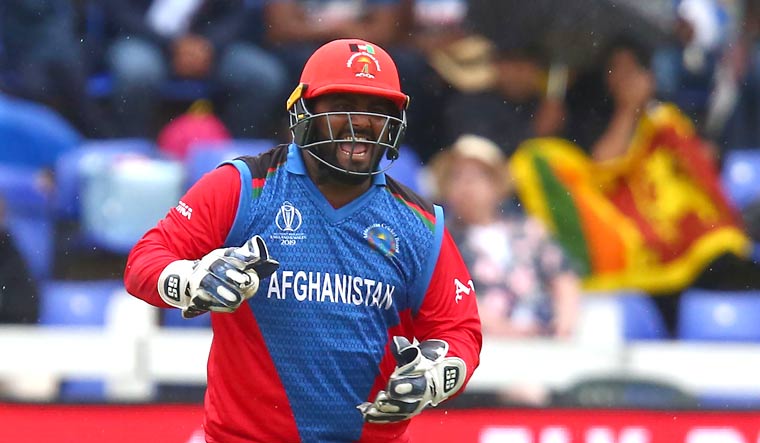 Afghanistan's Mohammad Shahzad celebrates Sri Lanka's Kusal Perera's dismissal during the 2019 World Cup group stage match at Sophia Gardens stadium in Cardiff, south Wales | AFP