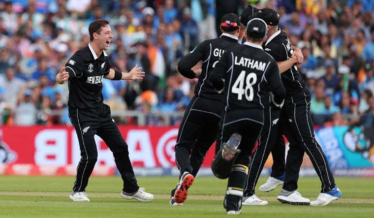 Matt Henry (left) celebrates the dismissal of Dinesh Karthik during the World Cup semifinal between India and New Zealand at Old Trafford in Manchester | AP