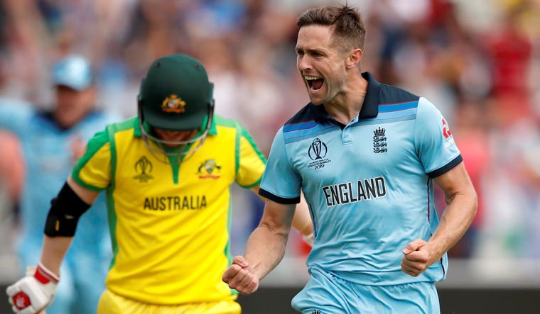 England's Chris Woakes celebrates taking the wicket of Australia's David Warner during the semifinal of the World Cup 2019, at Edgbaston in Birmingham | Reuters