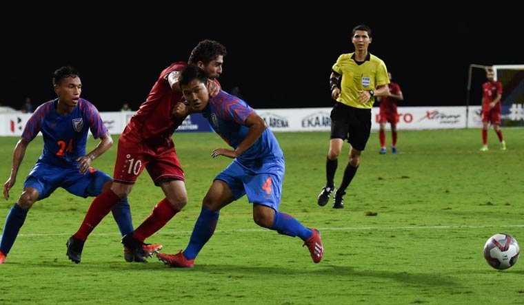 Syria's forward Firas Alkhatib (centre) and India's defender Jerry Lalrinzuala (right) fight for the ball during the Intercontinental Cup match | AFP