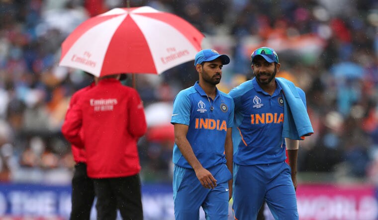 Bhuvneshwar Kumar and Jasprit Bumrah during the stoppage in play due to rain at the World Cup semifinal between India and New Zealand, at Old Trafford in Manchester | Reuters