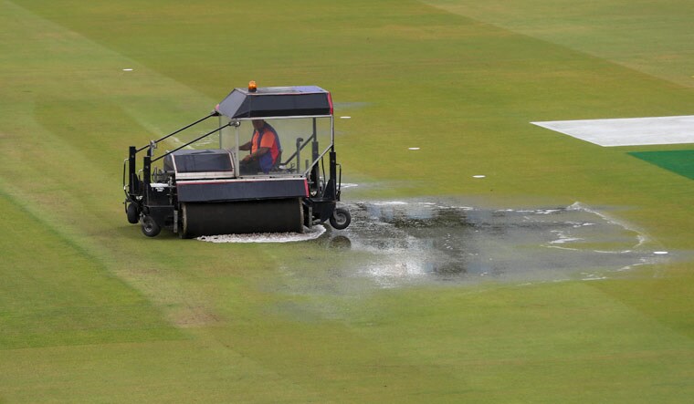 A super sopper is used to remove water after rain stopped play during the World Cup semifinal between India and New Zealand at Old Trafford in Manchester | AP