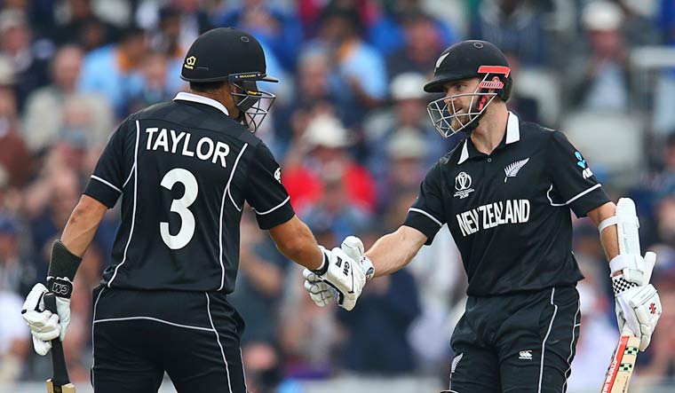 New Zealand's Ross Taylor (left) congratulates captain Kane Williamson on his half-century during the World Cup semifinal against India at Old Trafford in Manchester | AP