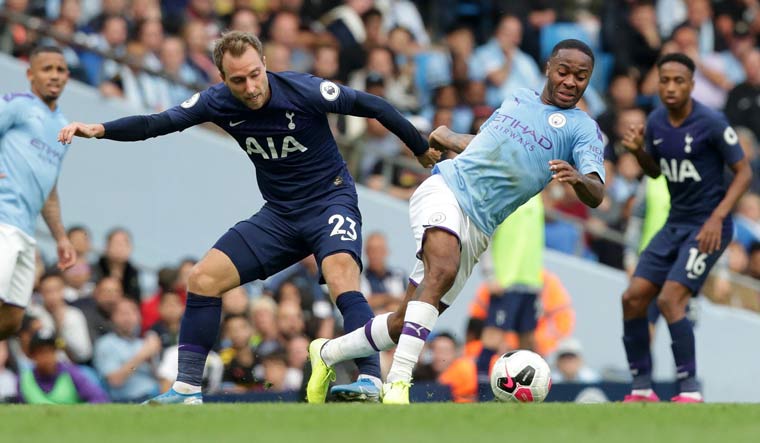 Tottenham Hotspur's midfielder Christian Eriksen (left) vies with Manchester City's midfielder Raheem Sterling during their Premier League match | AFP