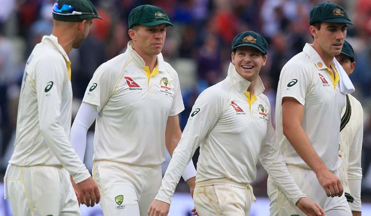 Australia's Steve Smith (3L) walks off the field with teammates at close of day's play on the opening day of the first Ashes cricket Test match between England and Australia at Edgbaston in Birmingham | AFP