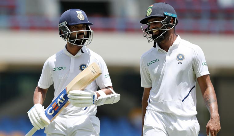 Ajinkya Rahane (L) and Hanuma Vihari walk to lunch after the first session of day four of the first Test cricket match against West Indies at the Sir Vivian Richards cricket ground in North Sound, Antigua and Barbuda, on Sunday | AP