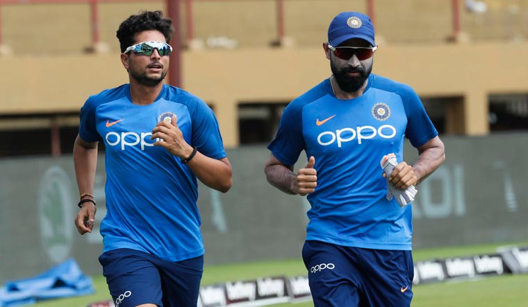 Indian players Kuldeep Yadav (left) and Mohammed Shami warm up at a training session ahead of a first ODI match against West Indies in Providence, Guyana | AP
