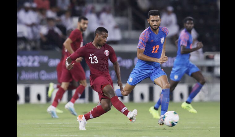 Qatar's Assim Madibo in action with India's Manvir Singh | Reuters