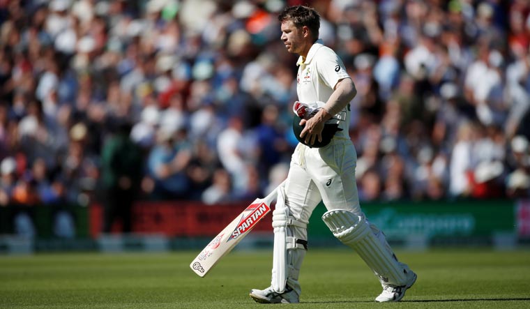 Australia's David Warner walks off the pitch dejected after losing his wicket to England's Stuart Broad | Reuters