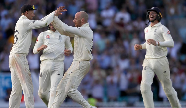 England's Joe Root, left, celebrates with teammates after winning the fifth Ashes test match between England and Australia at the Oval cricket ground in London, Sunday, Sept. 15
