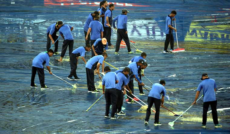 Stadium ground staff attempt to remove excess water from the HPCA Stadium in Dharamsala ahead of India's first T20 match against South Africa | PTI
