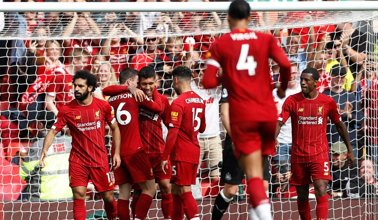 Liverpool's Mohamed Salah, left, celebrates with teammates after scoring his sides's third goal during the match between Liverpool and Newcastle | AP