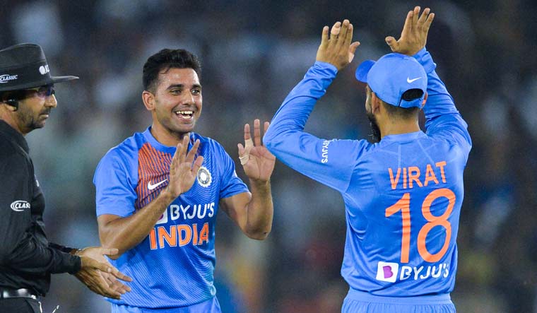 Deepak Chahar (second left) celebrates with captain Virat Kohli after dismissing South Africa's Reeza Hendricks during the second T20I match at Punjab Cricket Association Stadium in Mohali | AFP