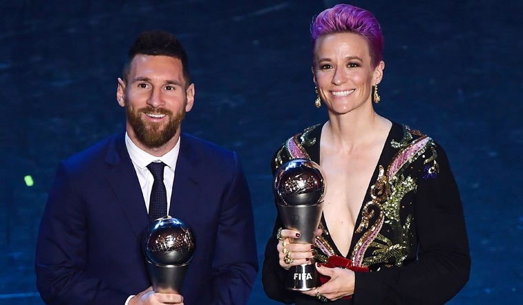 Argentina and Barcelona forward Lionel Messi (left) and US and Reign FC midfielder Megan Rapinoe pose with their Best FIFA Player of the Year awards | AFP