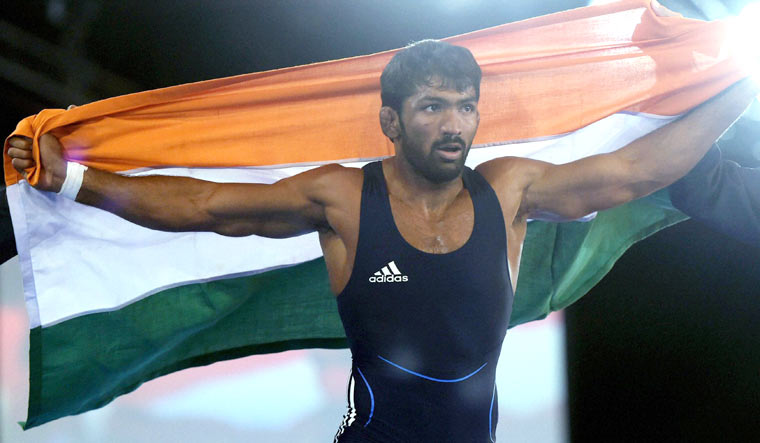 (File) Yogeshwar Dutt celebrates after winning the gold medal in the 65kg final at the Commonwealth Games 2014 in Glasgow, Scotland | PTI