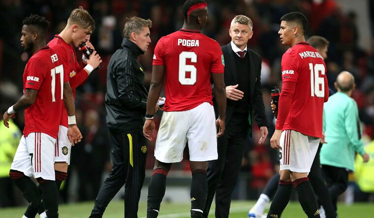 Manchester United's Paul Pogba and manager Ole Gunnar Solskjaer in discussion before penalty kicks during the Carabao Cup | AP
