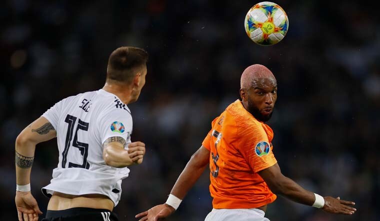 Netherlands' Forward Ryan Babel (R) and Germany's defender Niklas Suele vie for the ball during the UEFA Euro 2020 Group C qualification football match between Germany and the Netherlands | AFP
