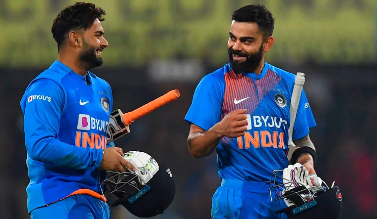 India captain Virat Kohli (right) speaks with teammate Rishabh Pant after winning the second T20I match of a three-match series, at the Holkar Cricket Stadium in Indore | AFP