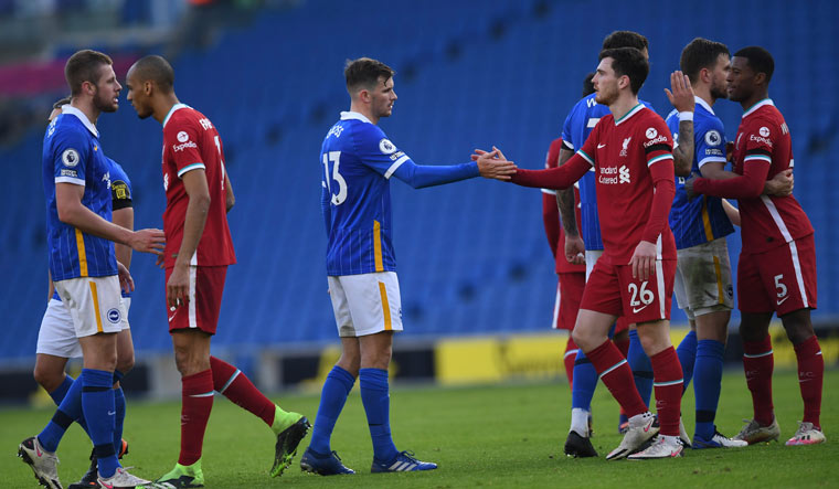 Brighton's Pascal Gross, left, greets Liverpool's Andrew Robertson at the end of the match | AP