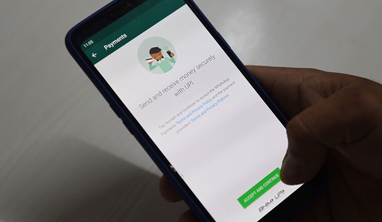 A user checks the Facebook's WhatsApp application payment feature on his mobile phone, in Faridabad | AFP