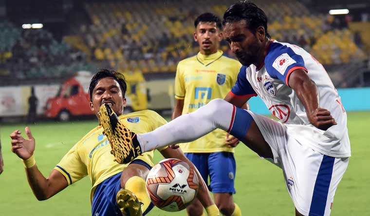 Players of Kerala Blasters FC (in yellow) and Bengaluru FC in action during their ISL match in Kochi | PTI