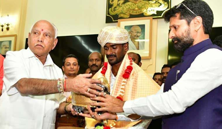 Karnataka Chief Minister B.S. Yediyurappa (left) honours Srinivas Gowda 