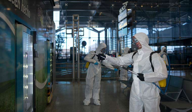 Military Emergencies Unit (UME) carry out a general disinfection at Malaga airport; Spain has so far reported over 8,700 cases of COVID-19 | AFP