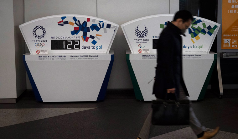 A man walks past a countdown display for the Tokyo 2020 Olympics in Tokyo | AP