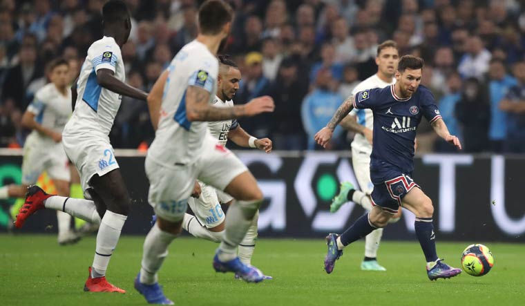 PSG's Lionel Messi, right, runs with the ball during the French League One soccer match between Marseille and Paris Saint-Germain | AP