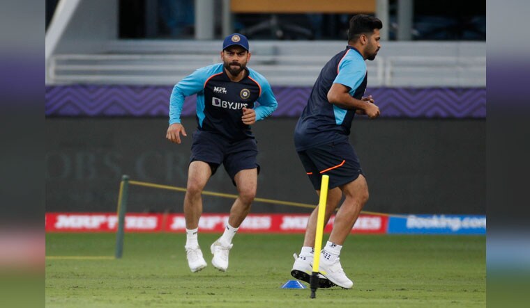 India's Virat Kohli, here seen training with Shardul Thakur, has expressed his intention to manage his workload better | Reuters