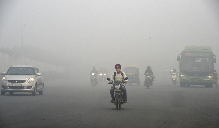 Vehicles ply amid low visibility due to a thick layer of smog, a day after Diwali celebrations in New Delhi | PTI